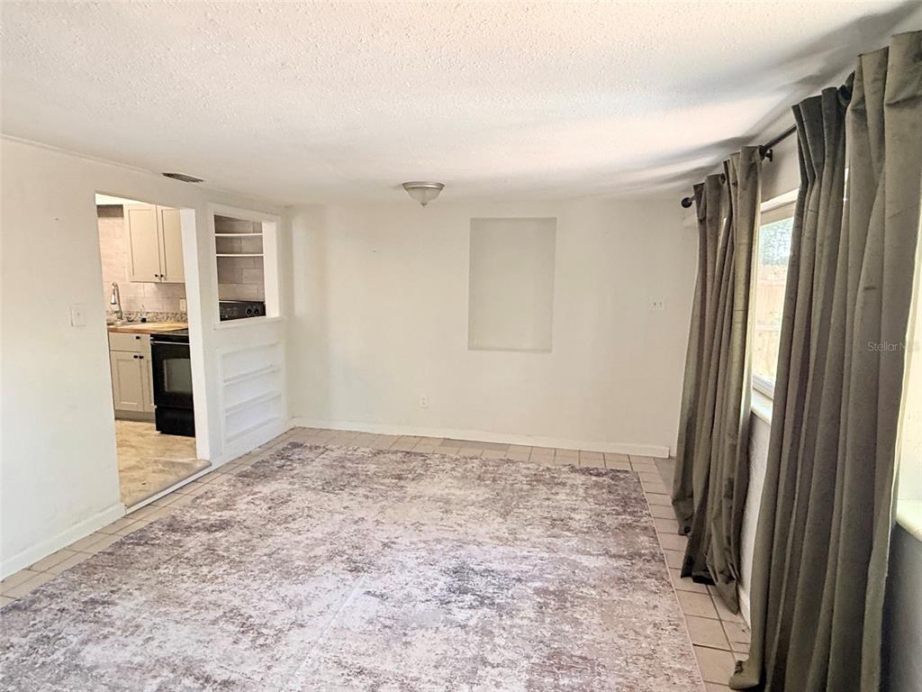 An interior room with tiled flooring, a recessed wall niche, and a doorway leading outside — 776 27TH AVENUE N UNIT 2, ST PETERSBURG, FL