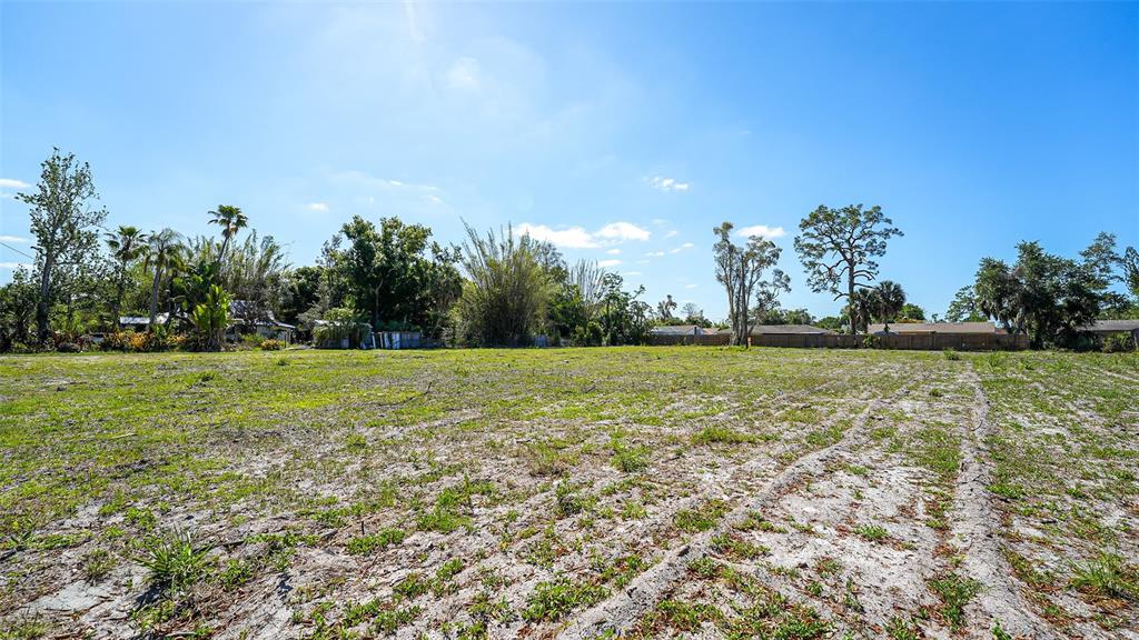 This aerial view shows a vacant lot and a nearby park area along a waterway — 2424 ASHTON ROAD, SARASOTA, FL