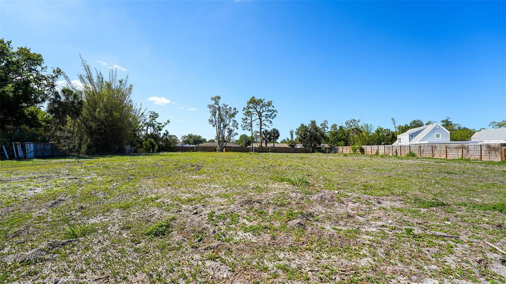 An aerial view shows a vacant, rectangular lot outlined in white within a residential neighborhood — 2424 ASHTON ROAD, SARASOTA, FL