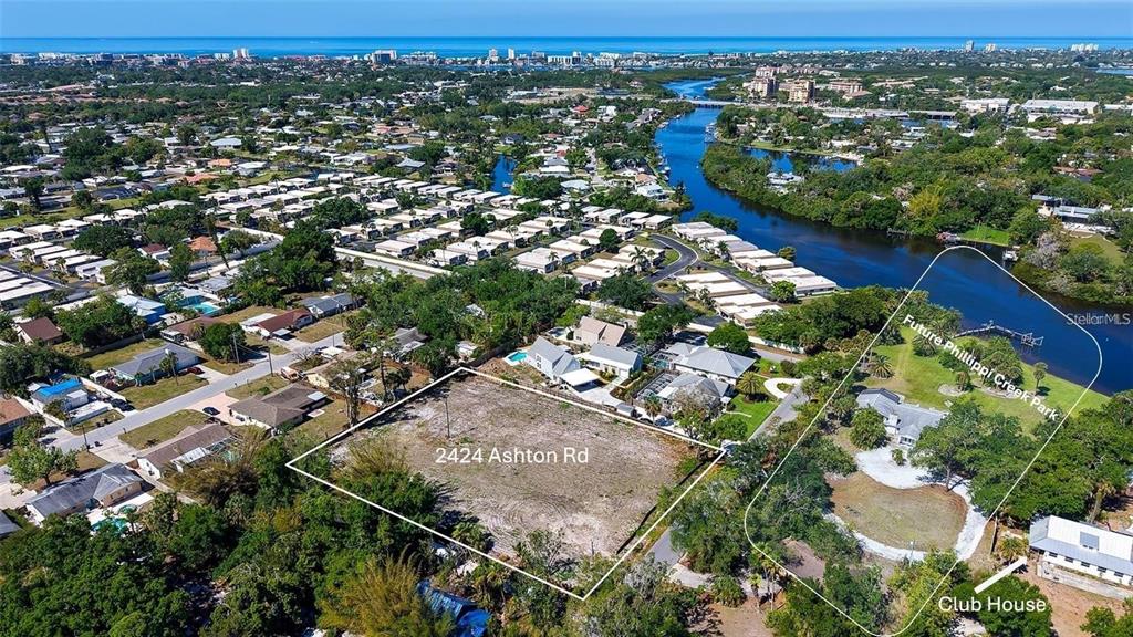 An aerial view shows four luxury houses with swimming pools arranged around a central driveway — 2424 ASHTON ROAD, SARASOTA, FL