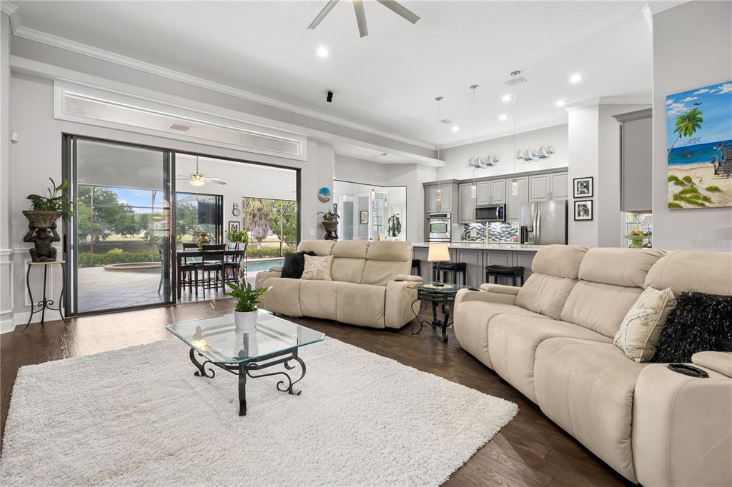 An aerial view shows a waterfront house with a pool, dock, and boat slips — 11325 PRESTON COVE ROAD, CLERMONT, FL