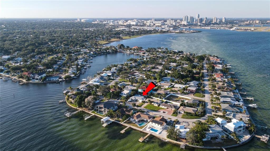 The exterior of a house features a white and gray facade with a front door — 2671 W BAY ISLE DRIVE SE, ST PETERSBURG, FL