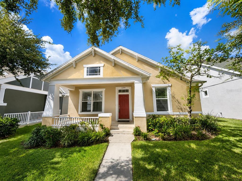 A yellow single-story house with a red front door and a covered front porch — 2240 FLORIDA SOAPBERRY BOULEVARD, ORLANDO, FL