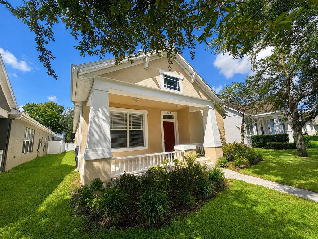 A single-story house with a front porch, white columns, and a red front door — 2240 FLORIDA SOAPBERRY BOULEVARD, ORLANDO, FL