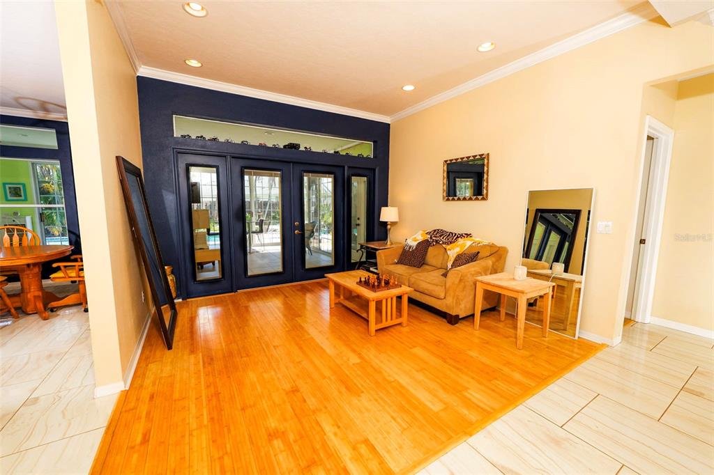 A two-story suburban house with a tan exterior, tiled roof, and a two-car garage — 3059 N RIO PLUMOSA N, INDIALANTIC, FL