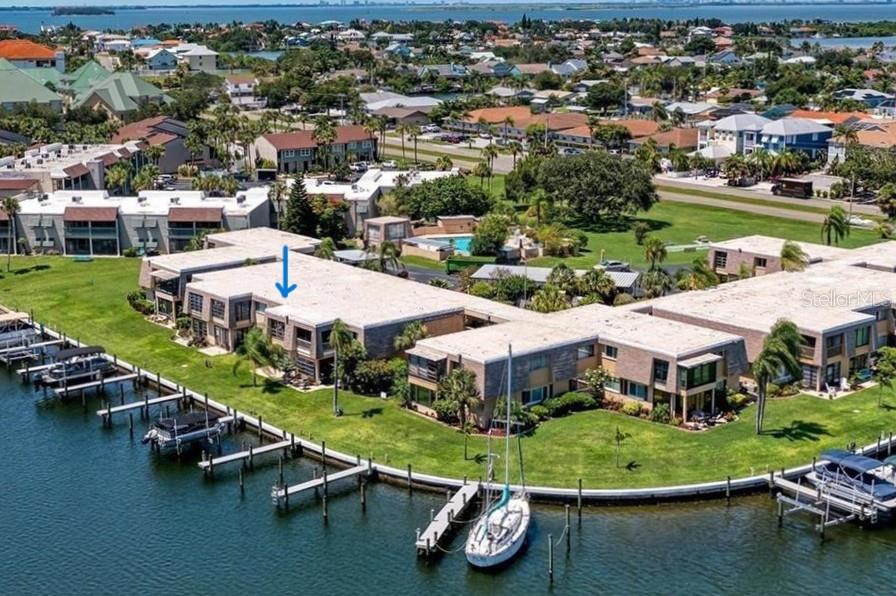 An aerial view of waterfront condominium buildings with private boat docks and a swimming pool — 1008 APOLLO BEACH BOULEVARD UNIT 210, APOLLO BEACH, FL