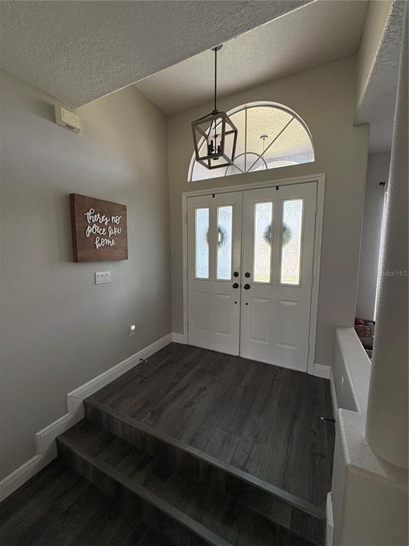 A single-story house with a gray exterior, a two-car garage, and a manicured front lawn — 8706 LINEBROOK DRIVE, TRINITY, FL