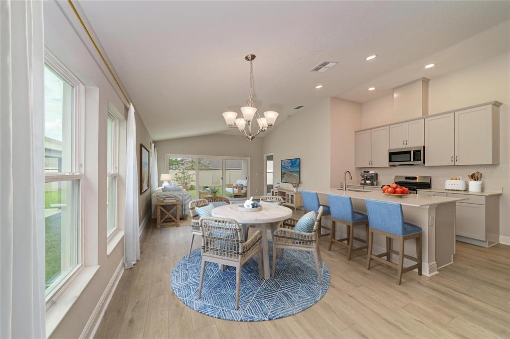 The exterior of a house under construction features a covered patio and tan siding — 12373 OAK  HILL WAY, PARRISH, FL