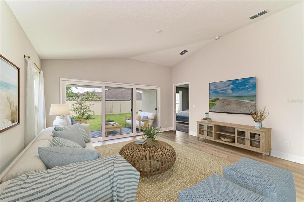 The exterior rear view of a new construction house shows a covered patio and yard — 12373 OAK  HILL WAY, PARRISH, FL