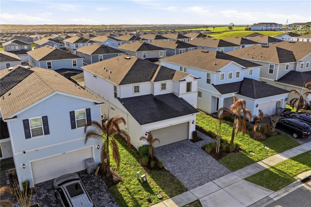 An aerial view shows several two-story suburban houses with paved driveways and small lawns — 1177 ALOHA BOULEVARD, DAVENPORT, FL