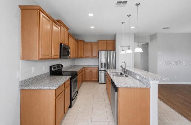 A green, single-story suburban house features two garage doors, a palm tree, and a driveway — 2317 CROSSTON CIRCLE, ORLANDO, FL