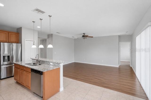 A green, single-story house with a two-car garage and a palm tree in the yard — 2317 CROSSTON CIRCLE, ORLANDO, FL