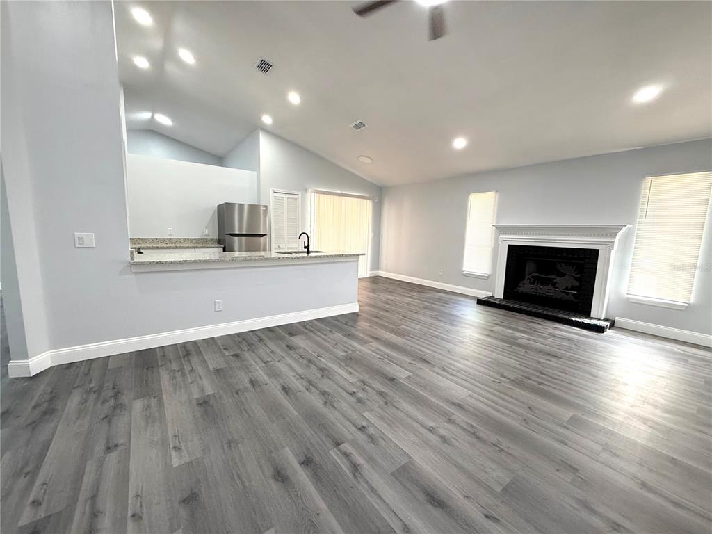A single-story house with a brick facade, a two-car garage, and a large front tree — 2419 LIELA LEE COURT, OCOEE, FL
