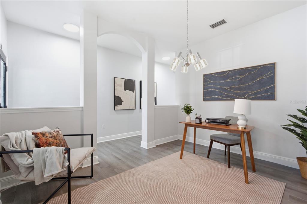 A home office area features a wooden desk, a modern chandelier, and a lounge chair — 9530 NATHANIEL LANE, LAND O LAKES, FL