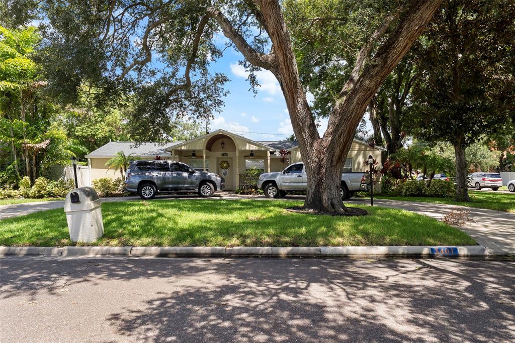 A single-story house with a circular driveway and large trees in the front yard — 3401 W SEVILLA STREET, TAMPA, FL