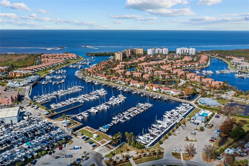 An aerial view shows a large marina filled with boats surrounded by residential buildings — 3336 SUNSET KEY CIRCLE UNIT D, PUNTA GORDA, FL