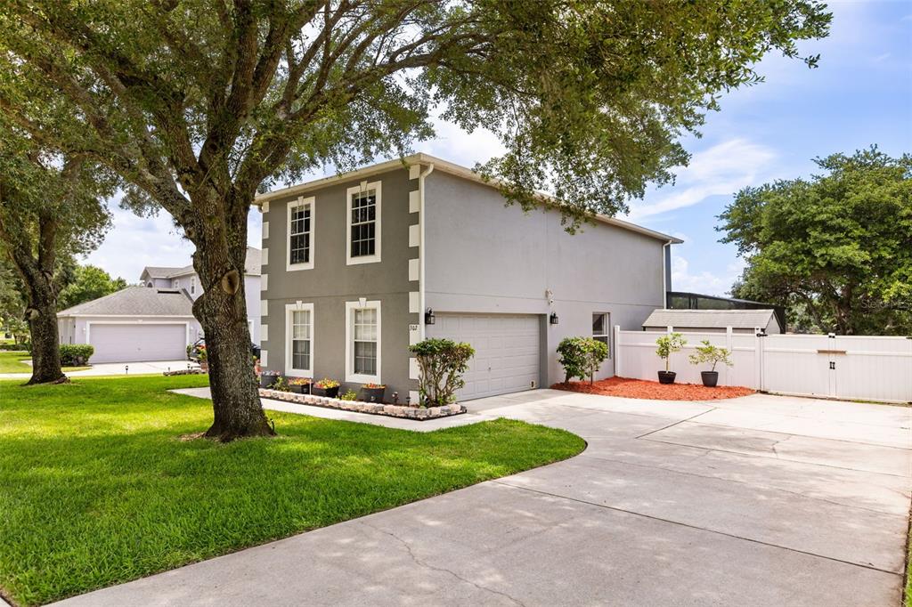 A two-story house with a gray exterior, white trim, and an attached garage — 302 LAKE SHEPARD DRIVE, APOPKA, FL