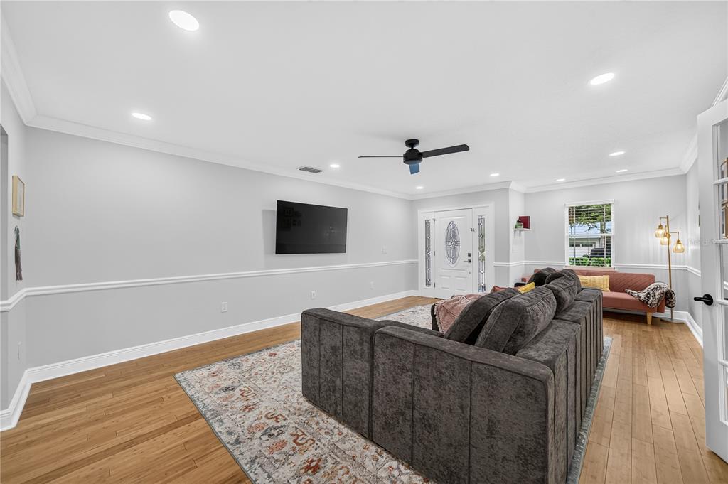 A patio features a wooden pergola with a fabric shade, modular seating, and a fire pit — 2028 ILLINOIS STREET, ORLANDO, FL