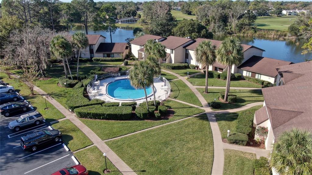 A kitchen with white cabinets, stainless steel appliances, a subway tile backsplash, and a skylight — 637 MIDWAY DRIVE UNIT B, OCALA, FL