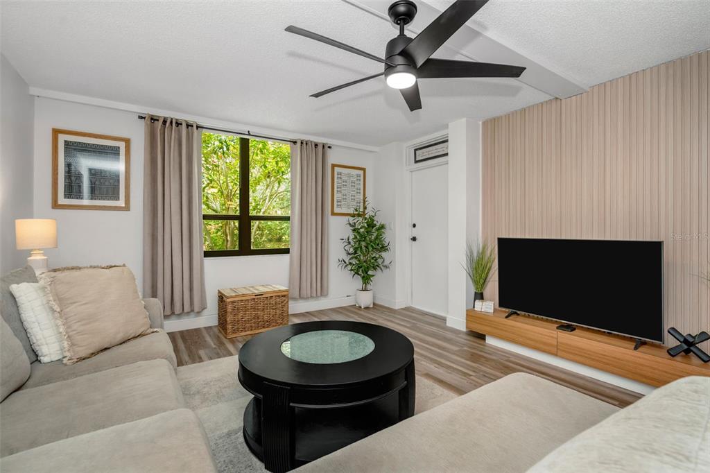 A kitchen features white cabinets, black appliances, a gray tiled backsplash, and a drop ceiling — 2614 COVE CAY DRIVE UNIT 102, CLEARWATER, FL