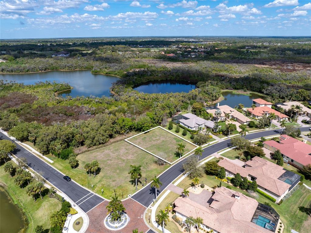 An aerial view shows a vacant residential lot outlined in white within a suburban neighborhood — 11708 RIVER SHORES TRAIL, PARRISH, FL
