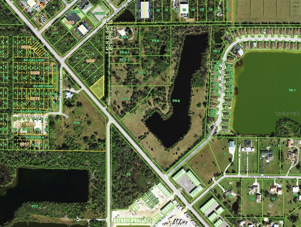This is an aerial map showing residential lots, a large pond, and surrounding undeveloped land — 3327 TAYLOR ROAD, PUNTA GORDA, FL