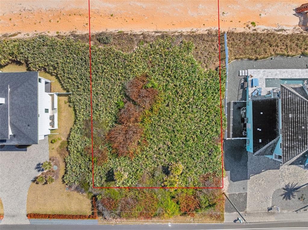 An aerial view shows a vacant, rectangular beachside lot bordered by two houses — 3101 N OCEAN SHORE BOULEVARD, FLAGLER BEACH, FL
