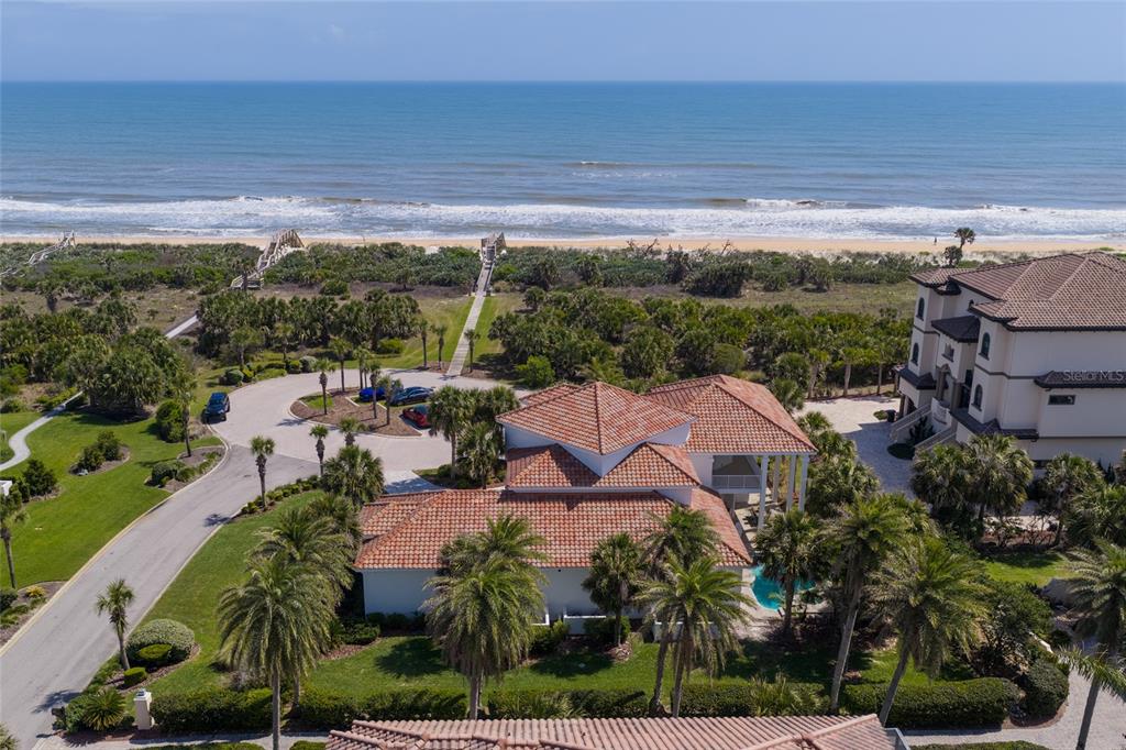 An aerial view of a coastal home with a tile roof near a sandy beach — 6 RIVIERA PLACE, PALM COAST, FL