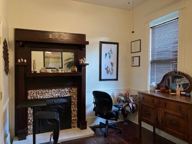 A room features a dark wood fireplace mantel, a desk chair, and a wooden dresser — 806 W DE LEON STREET, TAMPA, FL