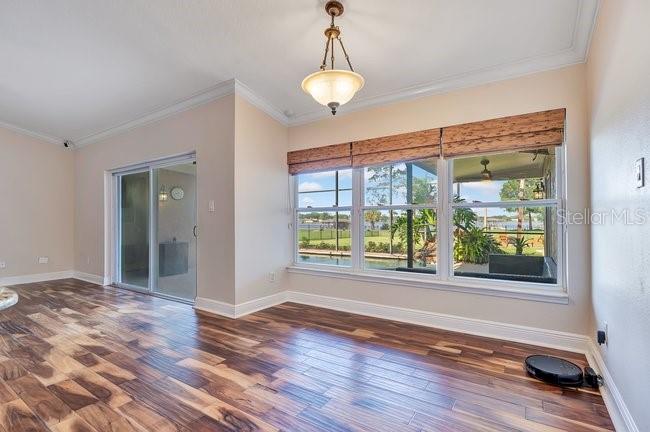 A wooden dock extends into a lake toward a covered boat slip with a kayak — 4512 BRIDGEWATER DRIVE, ORLANDO, FL