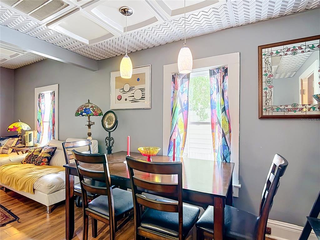 A dining room features a wooden table, chairs, patterned curtains, and a textured ceiling — 1417 11TH STREET, ST CLOUD, FL