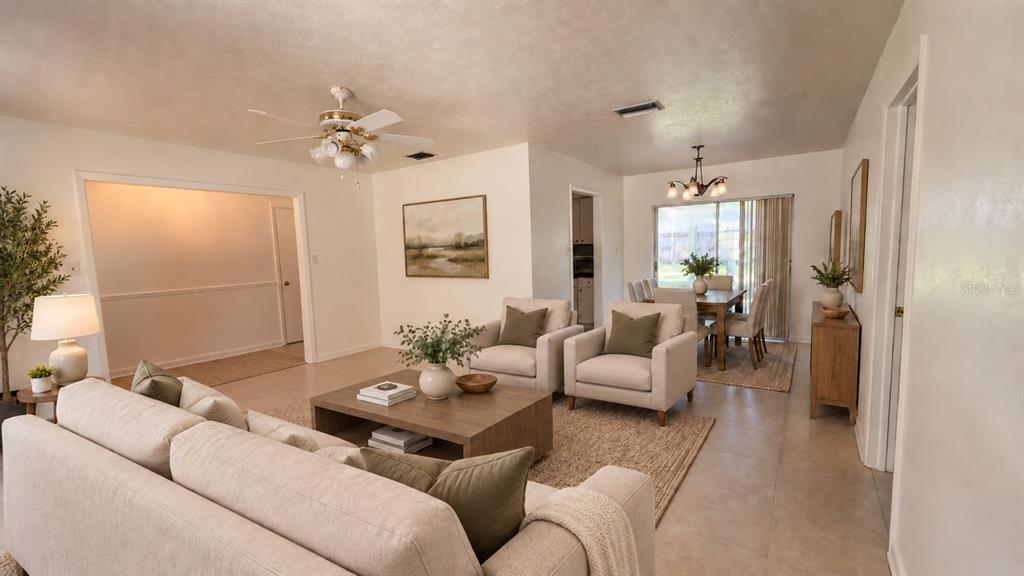 An empty room features light-colored tile flooring, white walls, and a ceiling fan — 2209 BOXWOOD WAY, BRANDON, FL