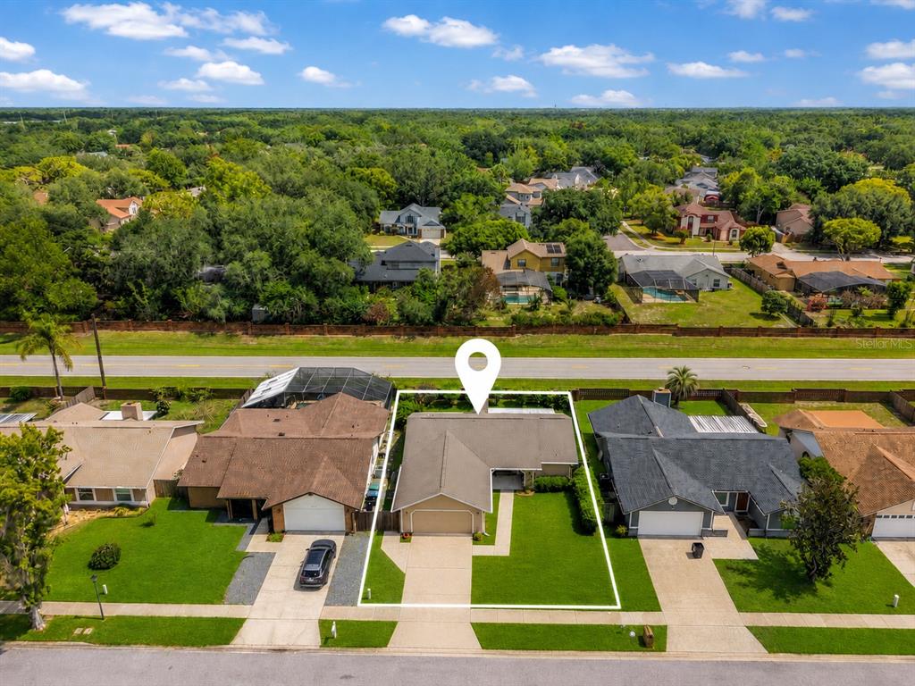 An aerial view shows a single-story suburban house with a white location pin marker — 10135 CHESHAM DRIVE, ORLANDO, FL