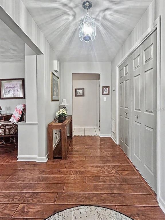 A single-story house with a white exterior, a large tree, and a concrete driveway — 1826 6TH STREET SE, WINTER HAVEN, FL