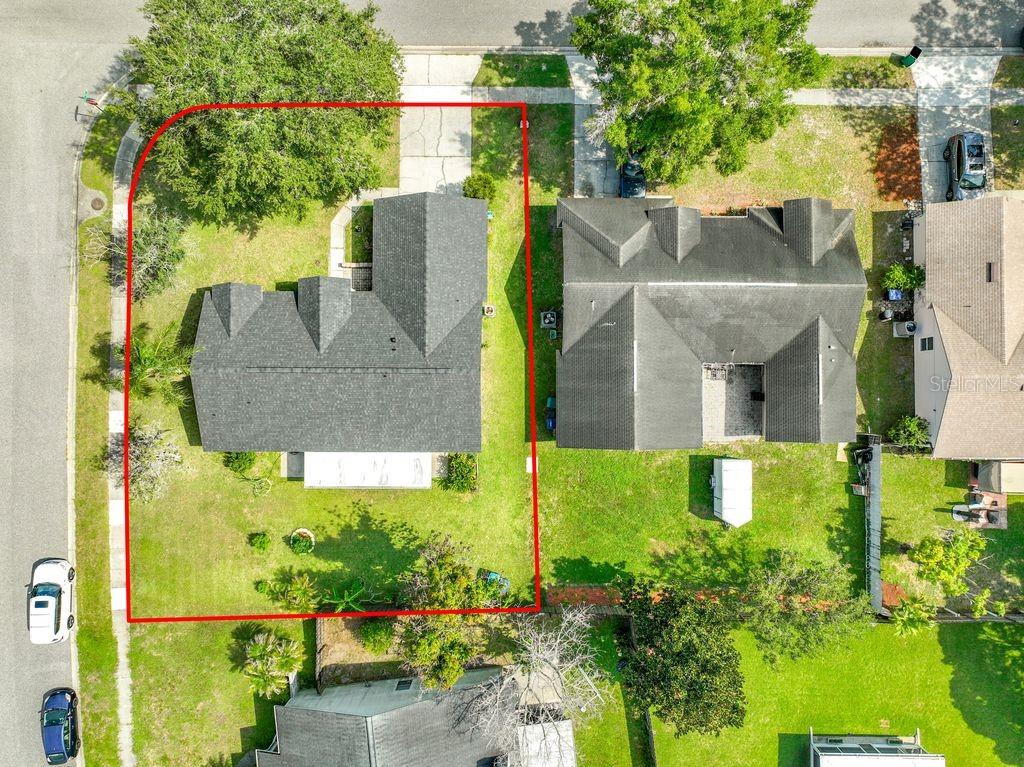 A kitchen features wood cabinets, granite countertops, a white refrigerator, and a stainless steel dishwasher — 8818 RESERVATION DRIVE, ORLANDO, FL