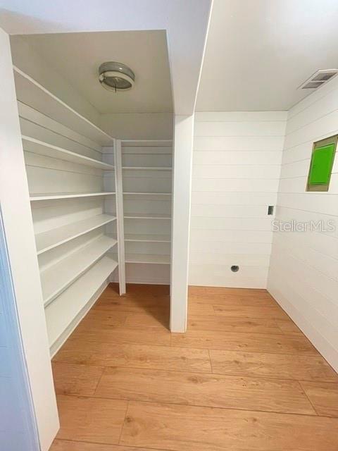 A walk-in pantry with white shelving, shiplap walls, and light wood-look flooring — 44 S CORTEZ AVENUE, WINTER SPRINGS, FL