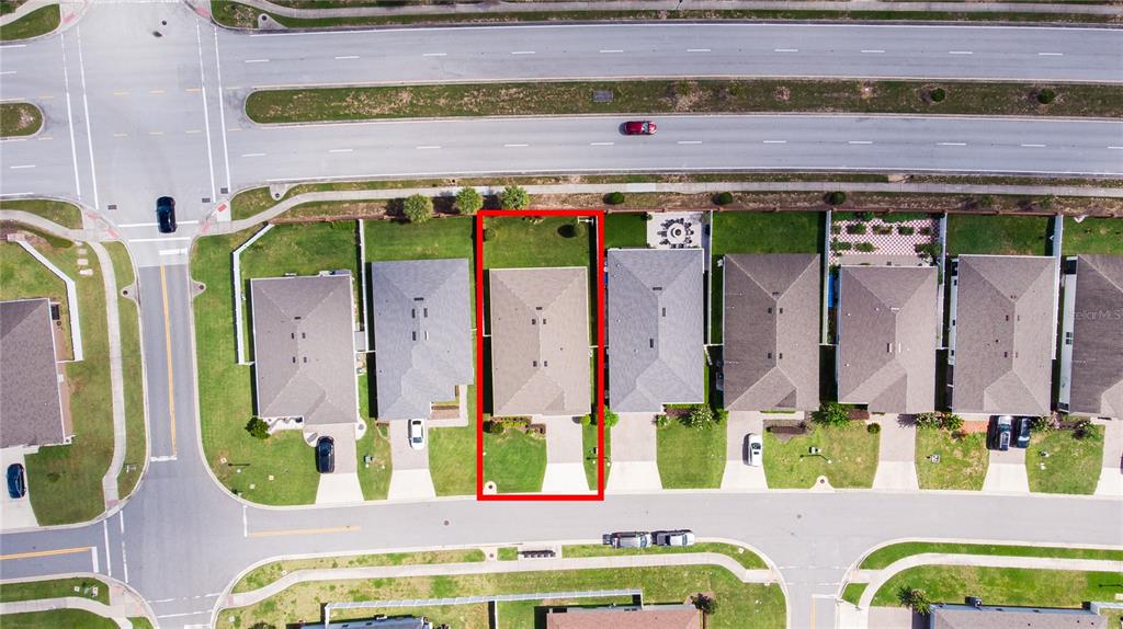 This aerial view shows a residential house highlighted in red within a suburban neighborhood — 16261 YELLOWEYED DRIVE, CLERMONT, FL