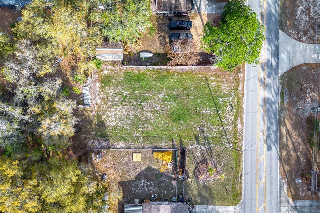 An aerial view shows a rural residential area with scattered houses, wooded lots, and ponds — LAKE GRIFFIN ROAD, LADY LAKE, FL