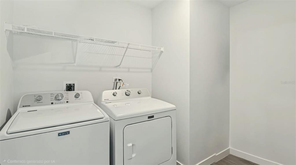 A laundry room features white walls, a wire shelf, and two white Maytag appliances — 409 CONWAY AVENUE, ST CLOUD, FL