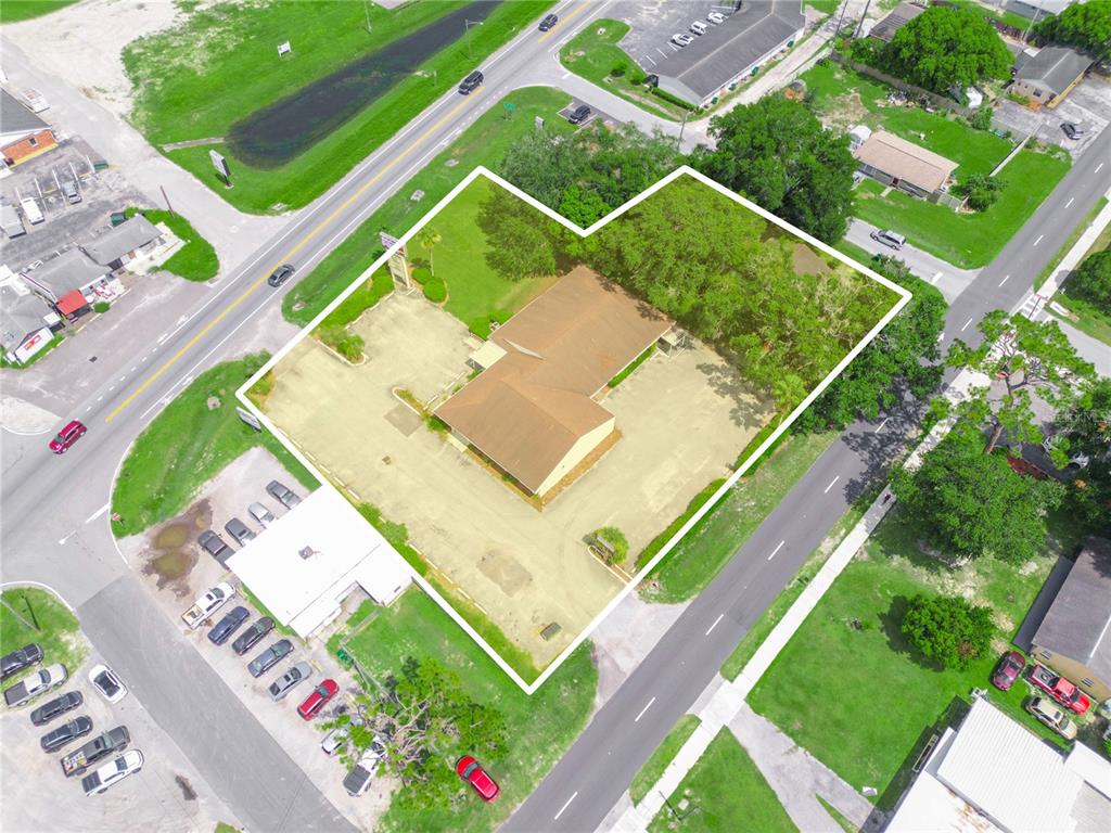 An aerial view shows a commercial building with a parking lot outlined in white — 5821 GALL BOULEVARD, ZEPHYRHILLS, FL
