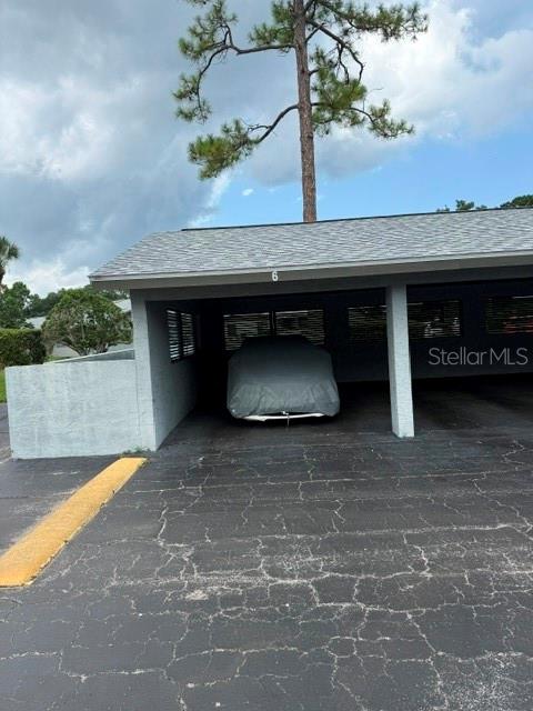 A covered parking carport with a car under a protective cover — 251 ORANGE GROVE DRIVE Unit 6, ORMOND BEACH, FL