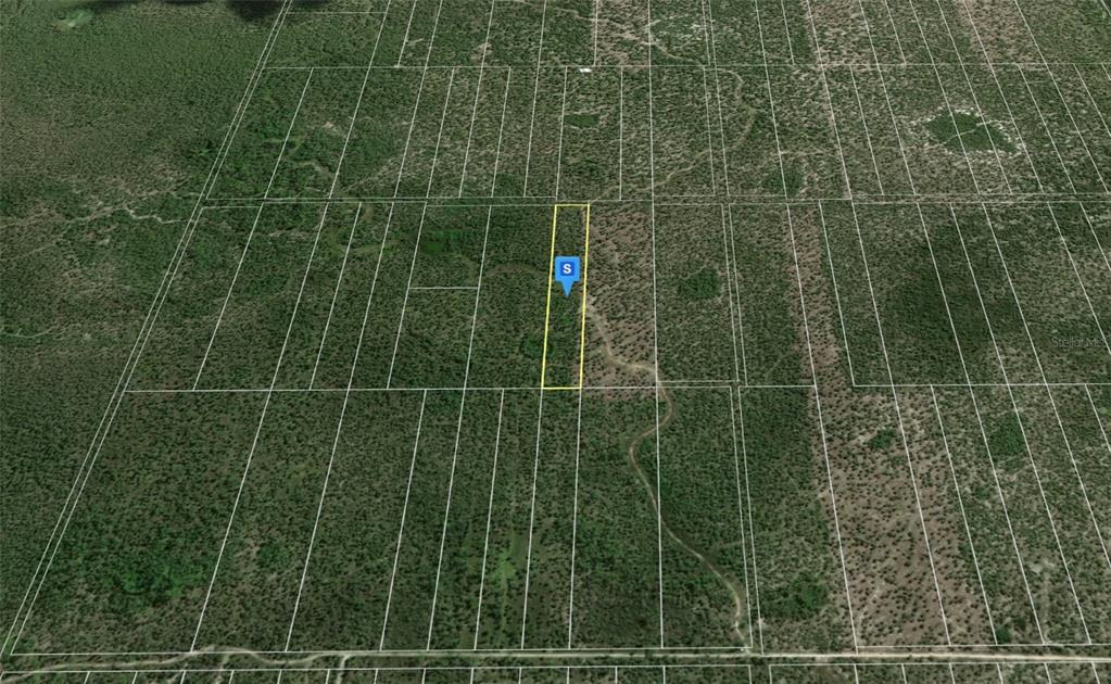 An aerial view shows a rectangular parcel of land outlined in yellow among surrounding lots — 3680 KAM LUCK DRIVE, NAPLES, FL
