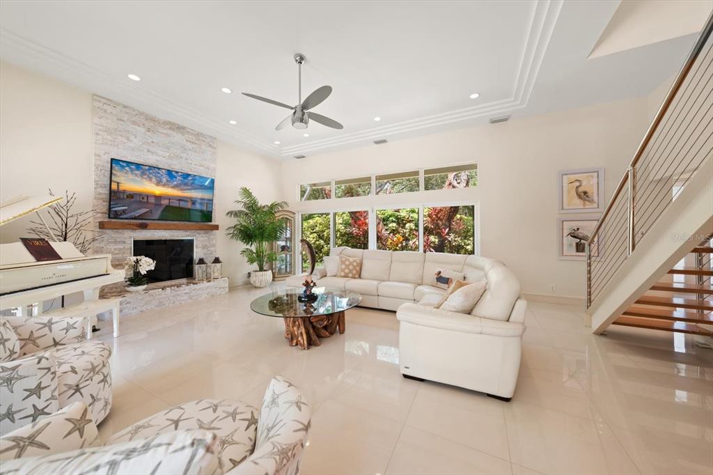 An elevated view of a backyard swimming pool with a spa, lounge chairs, and palm trees — 485 PARK AVENUE, BELLEAIR, FL