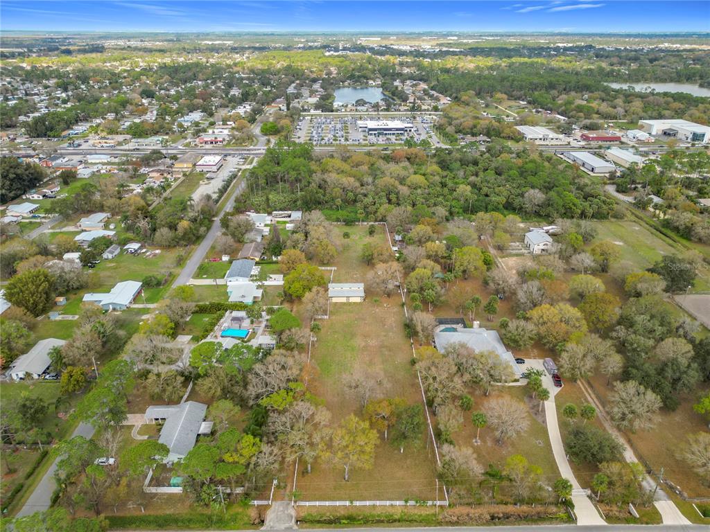 An aerial view shows a large, rectangular residential lot with trees and a small building — 3900 MIAMI AVENUE, MELBOURNE, FL