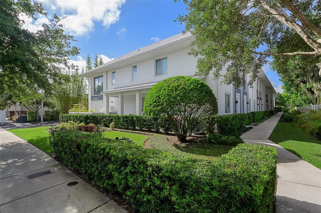 A two-story white building with a manicured hedge and a sidewalk along the side — 436 W SWOOPE AVENUE, WINTER PARK, FL