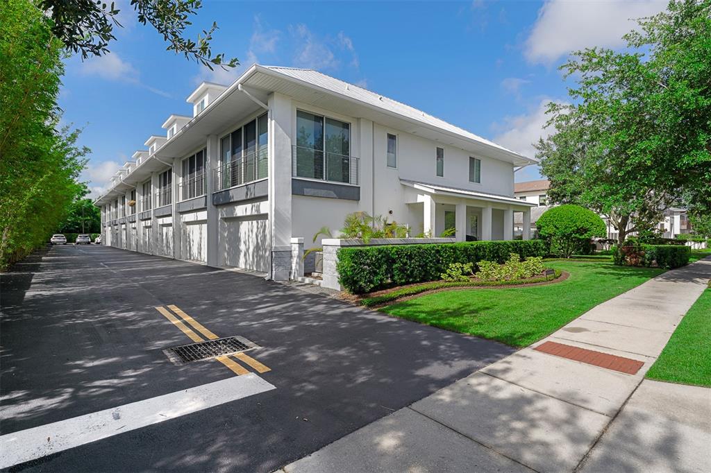 A multi-unit residential building with white walls, a metal roof, and a paved driveway — 436 W SWOOPE AVENUE, WINTER PARK, FL