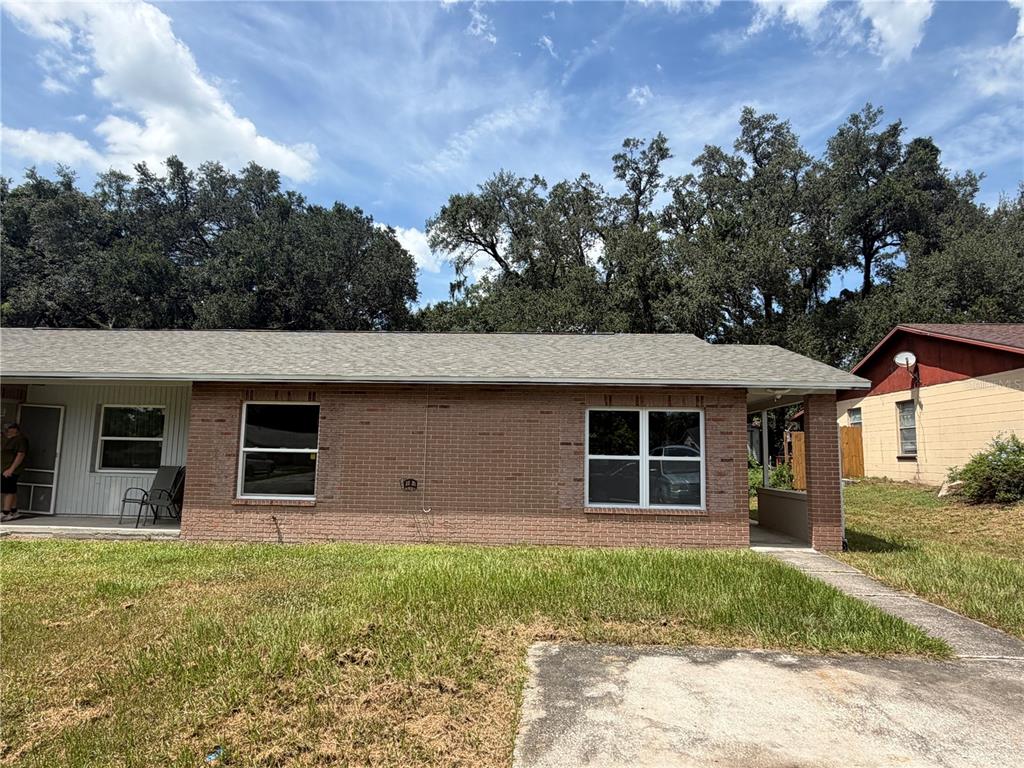 A single-story brick house with a gray shingled roof and a front lawn — 11510 VALENCIA DR UNIT 2, SEFFNER, FL