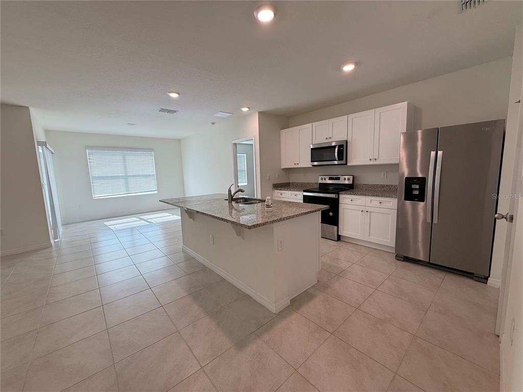 A tiled hallway leads to a white front door with arched entryways on both sides — 1344 SUGARWOOD STREET, DAVENPORT, FL