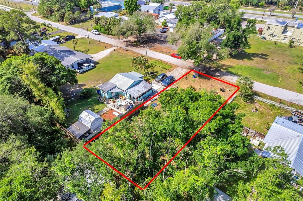 An aerial view shows a rectangular vacant lot outlined in red next to a house — 456 WASHINGTON AVENUE, OSPREY, FL