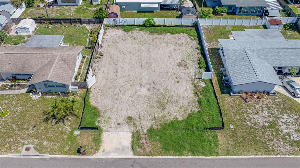 An aerial view of a vacant residential lot situated between two single-family homes — 13945 TRINIDAD DRIVE, SEMINOLE, FL